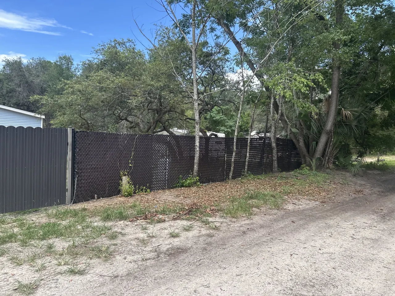Fence-Line Debris Cleanup after Stack’s JUNK Removal completed the work