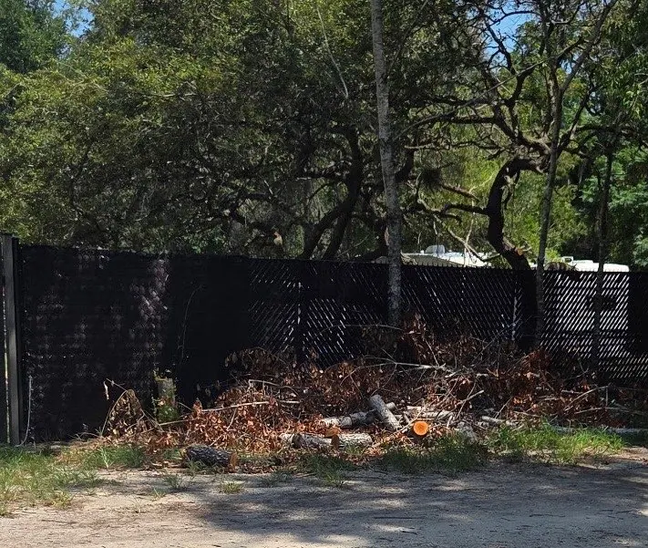 Fence-Line Debris Cleanup before Stack’s JUNK Removal completed the work